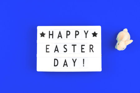 Happy Easter Day text on lightbox, festive background for holiday