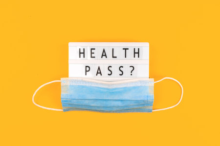 Health passport, vaccination background, with text and medical mask.