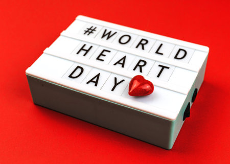 Background for World Heart Day 29th September with red heart, concept of love and health care
