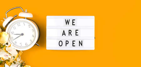 We are open sign banner background, lightbox with text message on a yellow background photoの写真素材