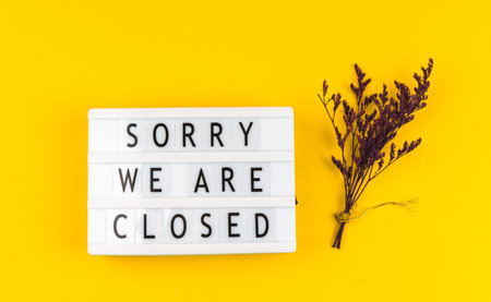 Sorry we are closed text inscription, sign concept on yellow backgroundの写真素材