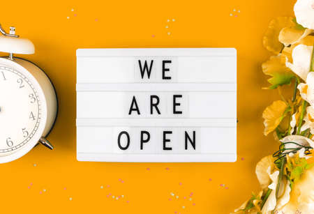 Lightbox with text message we are open, concept of the end of quarantine, yellow backgroundの写真素材