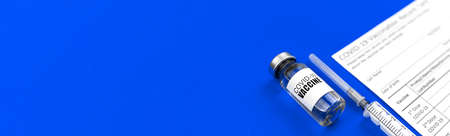 Vaccination banner with copy space, medical syringe and vaccine vial on a blue table backgroundの写真素材