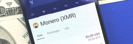 Monero XMR cryptocurrency on the screen, using a smartphone for buiyng crypto coins concept banner...