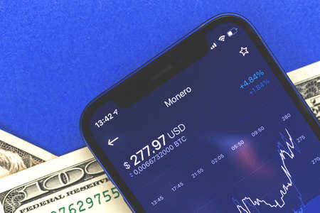 Monero cryptocurrency coin chart on the screen, mobile trading and stock exchanges finance concept photoの写真素材