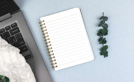 Business office desktop, mockup with blank notepad, top view laptop on the tableの写真素材