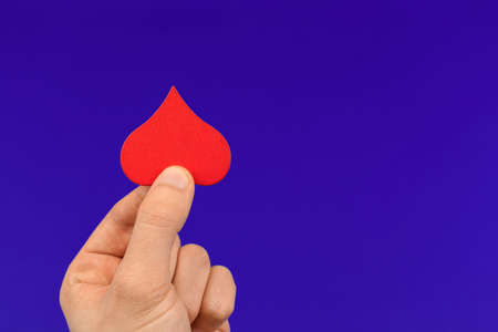 The concept of world blood donor day, charity and love, donate and heping hand with red heart in form of drop, healthcare concept photoの写真素材