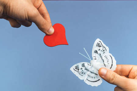 Charity background concept, boy's hand gives a red heart to the nature, save earth photoの写真素材
