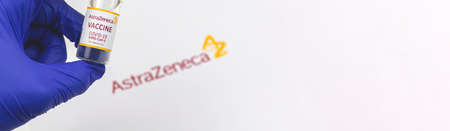 Kharkov, Ukraine - April 18, 2021: Europe vaccination banner, Astrazeneca vaccine vial in a doctor hand, copy space, immunization concept imageのeditorial素材