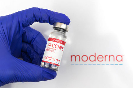 Kharkov, Ukraine - April 18, 2021: Doctor in gloves hold Moderna vaccine, American COVID-19 vaccine close upのeditorial素材