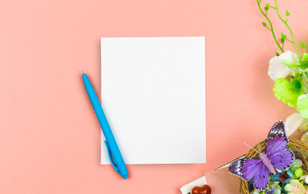 Mother's Day greeting card mockup concept with blank white paper and pen, spring composition with...