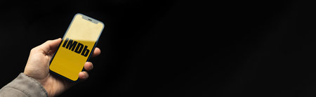 Kharkov, Ukraine - April 20, 2021: iMDB app logo banner with black background, copy space photo, man...