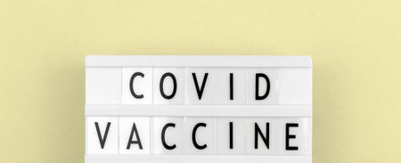 Covid vaccine text message banner concept, top view and flat lay backgroundの写真素材