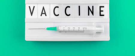 Vaccine text banner concept with medical syringe close up, panoramic wide photo for vaccinationの写真素材