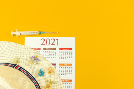 Concept of traveling 2021 during coronavirus pandemic, safe travel and summer vacation with vaccine vialsの写真素材