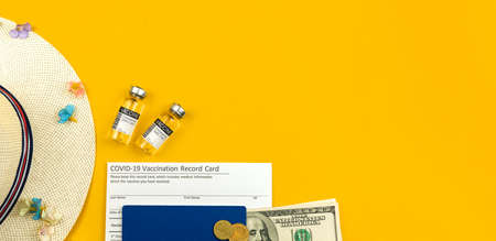 Summer travel being vaccinated concept with vaccine vials on a yellow background, flat lay photo top view composition with copy spaceの写真素材