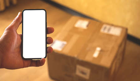 Shipping delivery service mockup, smartphone in hand of customer with blank white screen photoの写真素材