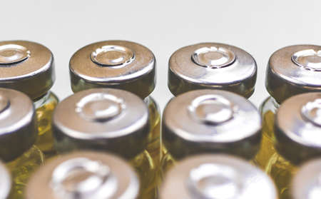 Develompent of new vaccine covid-19, close-up of coronavirus vaccine vials on white background, manufacture bio science conceptの写真素材