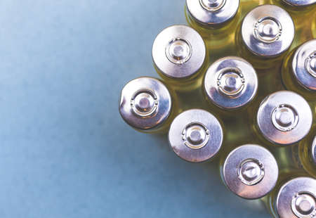 Top view of coronavirus vaccine vials, laboratory research and vaccine manufacture concept backgroundの写真素材