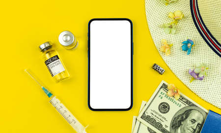 New normal travel during COVID-19, mockup screen and flat lay yellow background, summer vacation conceptの写真素材