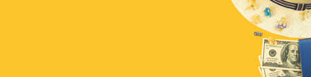 Travel banner with money and passport on yellow background with copy space, place for text, top view photo of summer straw hat and tropical flowersの写真素材