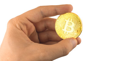 Bitcoin in hand close-up on white isolated background, cryptocurrency