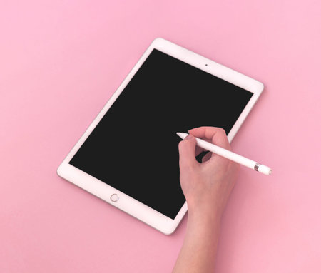 Kharkov, Ukraine - May 5, 2021: Woman using Apple iPad with stylus pen, mockup of digital tablet for...