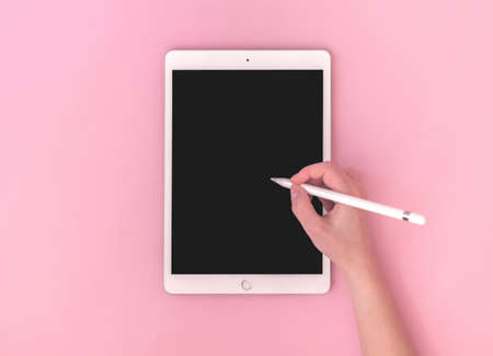 Kharkov, Ukraine - May 5, 2021: Woman using Apple iPad with stylus pen, mockup of digital tablet for artist, top view photoのeditorial素材