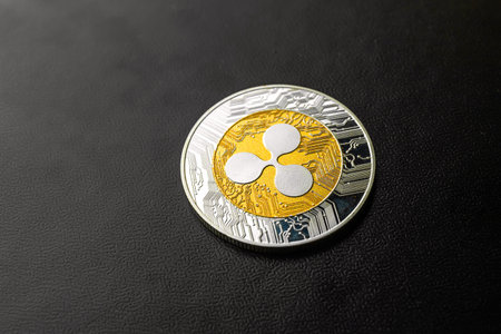 Ripple coin close-up on black background, cryptocurrency business and finance concept