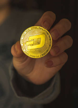 Woman hand with dash crypto coin, cryptocurrency exchange and investment conceptの写真素材