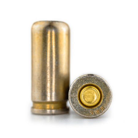 Close up of 9mm cartridge for a pistol gun, bullet isolated on white background