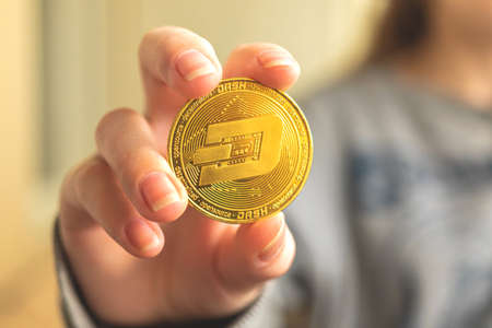 Dash crypto coin in hand close-up business backgroundの写真素材