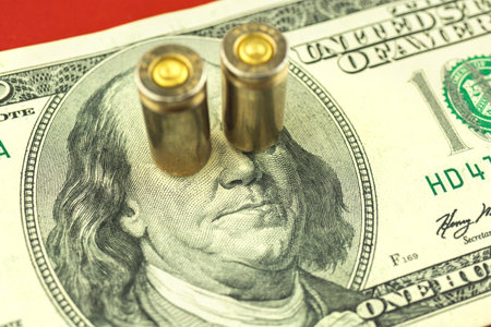 Concept of dirty money, Benjamin Franklin with bullets, caricature of bloody dollars