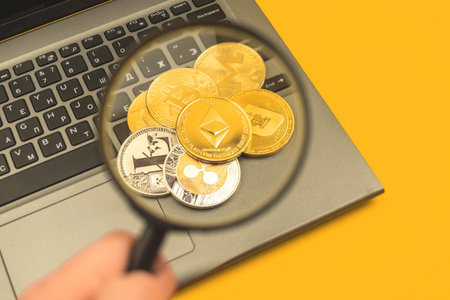 Stack of crypto coins with Ethereum on top, man hold magnifying glass, crypto currency financial and...