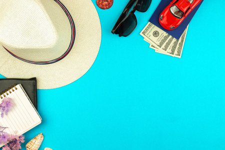 Summer composition flat lay, frame pr border of tropical hat, sunglasses, toy car and money on...