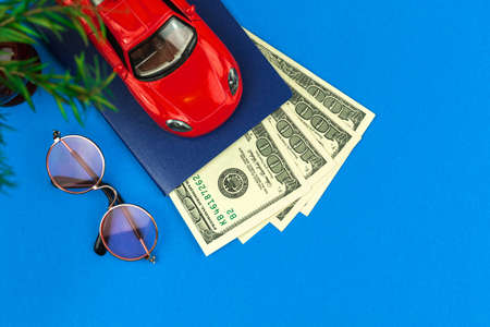 Trip by a car, summer travel and vacation concept background with toy car and money, holiday photoの写真素材