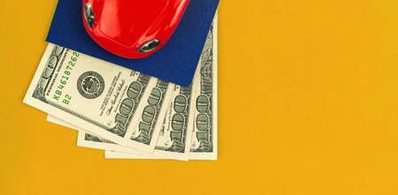 New car buy concept with red car and money on yellow background, selling and buying template photoの写真素材