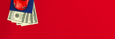 Selling new car banner with red car and money, copy space and top view composition