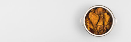 Banner fried cooked chicken in a saucepan on white silver flat lay background, a place to cook...