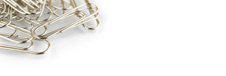Metal paper clips top view white background office desk, isolated and copy space photoの写真素材