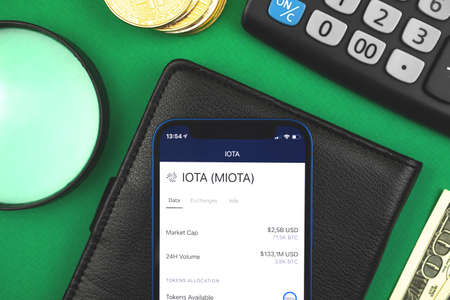 IOTA MIOTA crypto currency online banking concept, with your mobile phone, finance crypto trading and exchange backgroundの写真素材