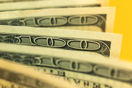Close-up of bunch dollar bills with selective focus, one hundred dollar banknotes macro