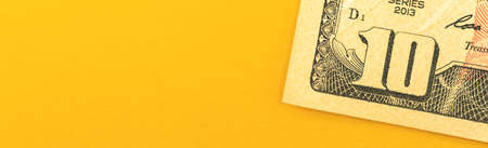 Small investment concept, money invest concept with ten dollar bills on office desktop background, banner with copy space photoの写真素材