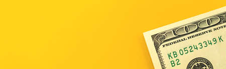 Finance investment concept, banner with money US one hundred dollar bill on a yellow background with copy space, top viewの写真素材