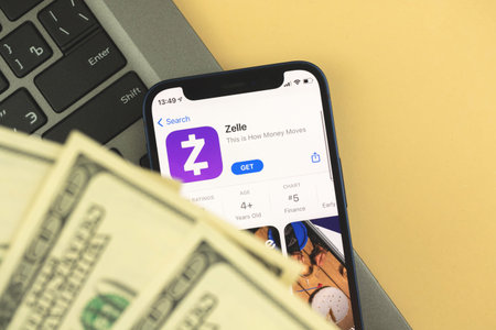 Kharkov, Ukraine - May 28, 2021: Zelle app on the screen, mobile phone banking and cash applications