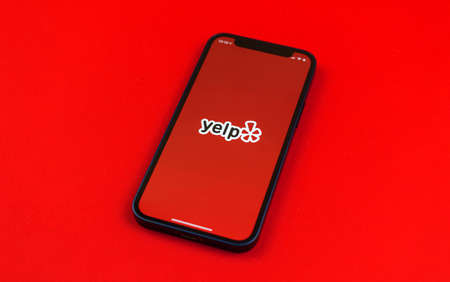 Kharkov, Ukraine - May 28, 2021: Yelp logo on smartphone screen, american develops, hosts and markets yelp.com website and app for mobile phonesのeditorial素材