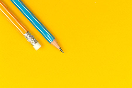 School lead pencil flat lay background with yellow desktop, education composition with copy space,...
