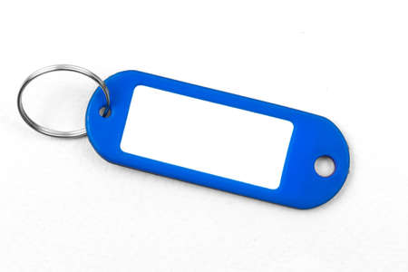 Blank blue name badge mockup design, plastic mamecard with key ring on a white background, copy spaceの写真素材