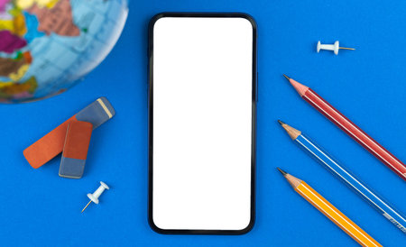 School education and learning mobile phone mockup concept, blank white screen, table with pencils,...