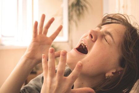 Young girl screams from hopelessness, failure at work, lost time and mental fatigue conceptの写真素材